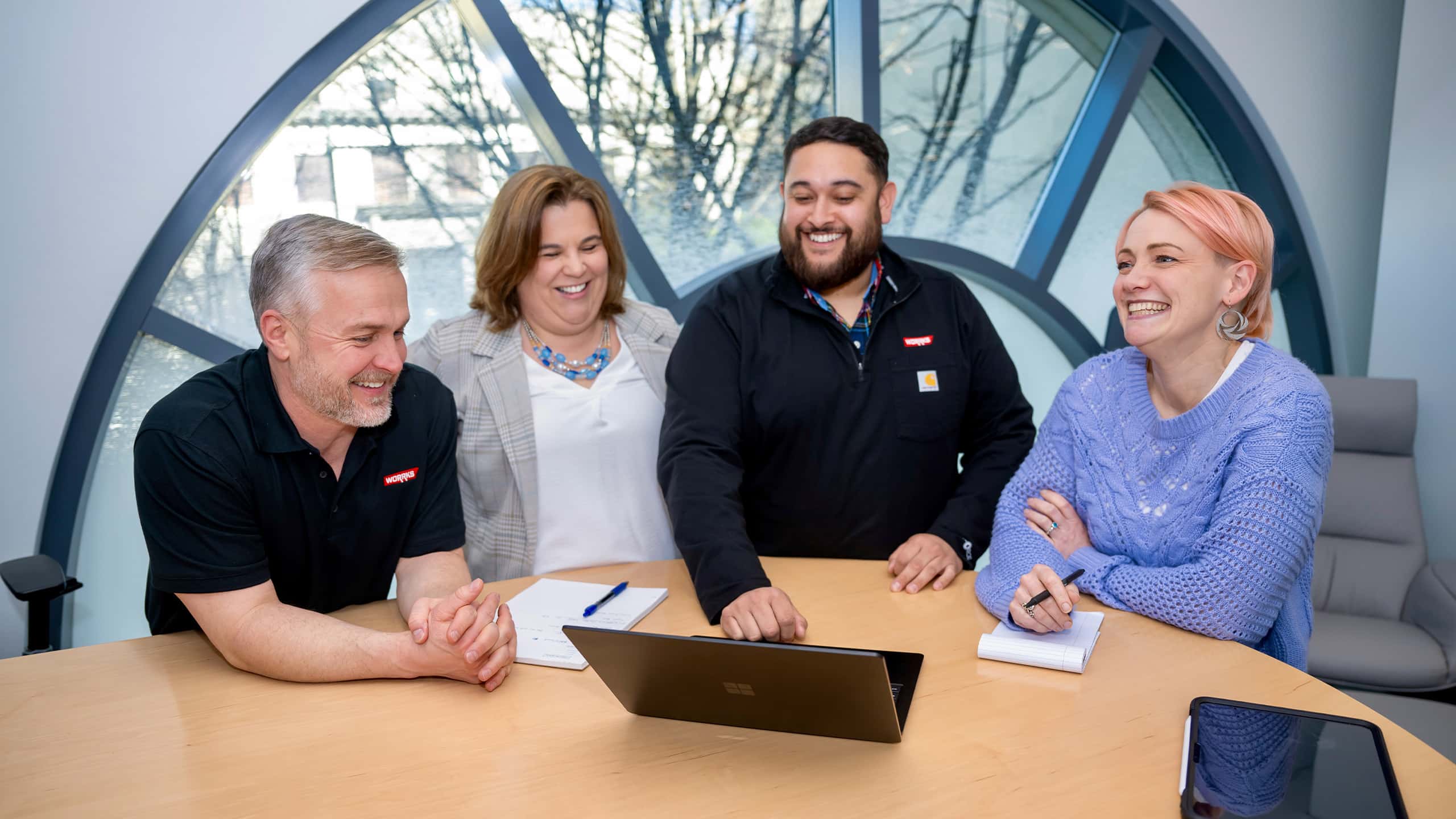 WORRKS employee looking at laptop