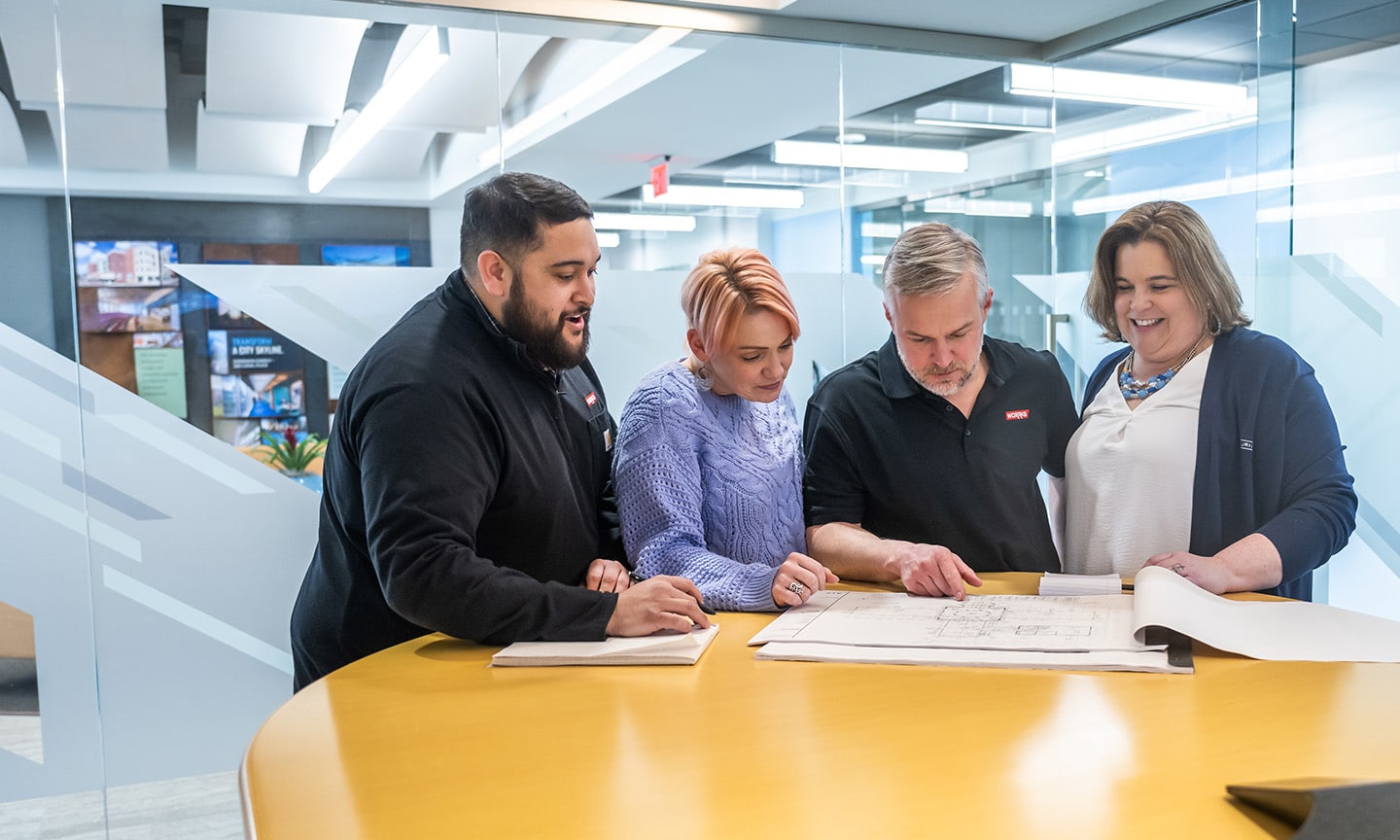group of people looking at paper diagrams