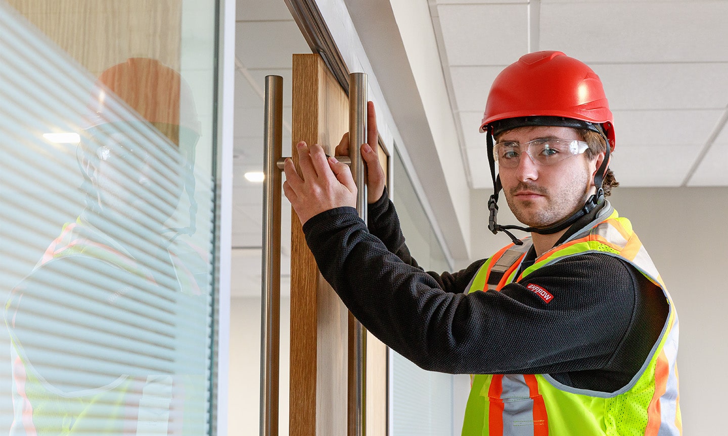 WORRKS employee installing sliding barn door in office
