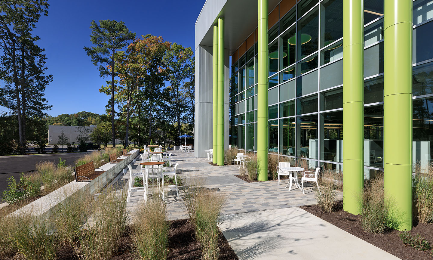 Walkway with tables and chairs outside Feed More