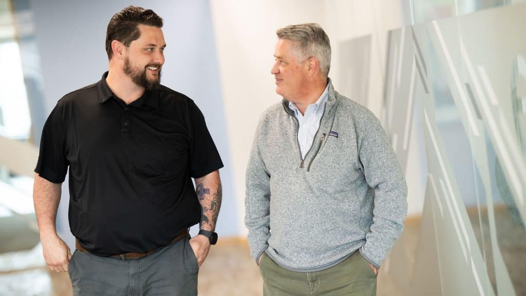 A WORRKS employee walking and talking to a client